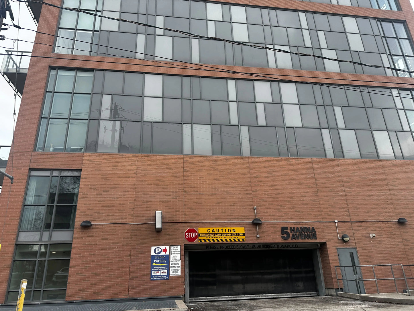 Vehicle entrance to 5 Hanna Ave parking garage Toronto showing public parking sign and automatic door for World Cup 2026 BMO Field parking